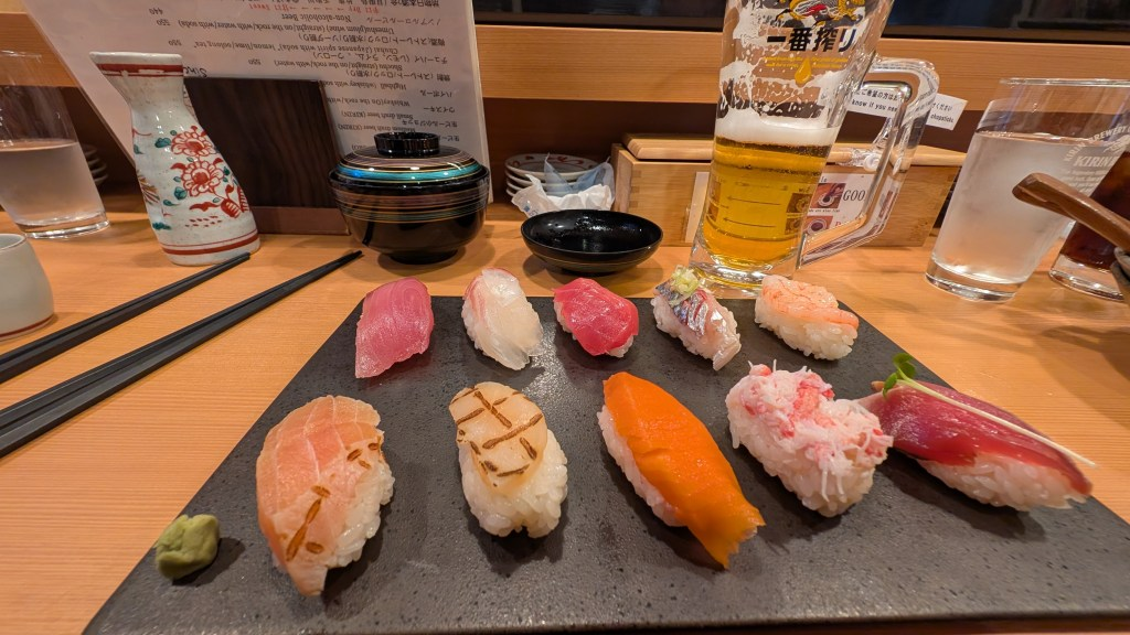 Kenroku-en garden in Kanazawa with cherry blossoms and stone lanterns